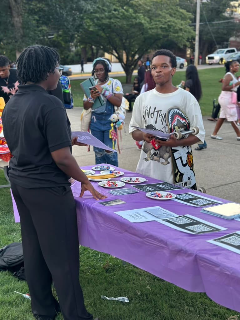Fellowship members welcoming students during a campus fair